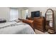 This well-lit bedroom features neutral tones and is equipped with a large dresser to maximize storage space at 4344 Spa Dr. # 605, Little River, SC 29566