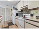 Updated kitchen featuring white appliances, wood floors, and ample cabinet space at 4344 Spa Dr. # 605, Little River, SC 29566