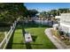 Backyard featuring a putting green, cornhole, a fenced pool, and a grill at 4806 S Ocean Blvd., Surfside Beach, SC 29575