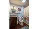 Well-lit bathroom with a vanity, stylish mirror, and a shower with a decorative curtain at 4806 S Ocean Blvd., Surfside Beach, SC 29575