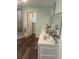 Bathroom with a modern vanity, dual sinks, and a walk-in shower at 4806 S Ocean Blvd., Surfside Beach, SC 29575