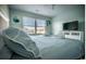Tranquil bedroom with a large window, plush bedding, and a relaxing view at 4806 S Ocean Blvd., Surfside Beach, SC 29575