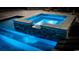 A beautifully lit hot tub featuring stone accents and cascading water for a luxurious and relaxing experience at 4806 S Ocean Blvd., Surfside Beach, SC 29575