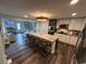 Open kitchen with an expansive island, barstool seating, stainless appliances, and hardwood floors at 4806 S Ocean Blvd., Surfside Beach, SC 29575