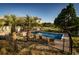 Backyard pool area surrounded by lush palms and a well-maintained lawn at 4806 S Ocean Blvd., Surfside Beach, SC 29575