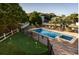 An aerial view of a fenced pool area, including an adjacent putting green and lush trees at 4806 S Ocean Blvd., Surfside Beach, SC 29575
