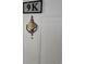 Close-up of a door with a '9K' sign and a brass knocker with 'Smith' inscribed on it at 500 Fairway Village Dr. # 9-K, Myrtle Beach, SC 29588