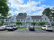 Light gray townhome with well-maintained lawn, parking, and inviting curb appeal on a partly cloudy day at 500 Fairway Village Dr. # 9-K, Myrtle Beach, SC 29588