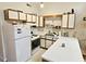 Bright kitchen with white appliances, laminate countertops and wooden trimmed cabinetry at 500 Fairway Village Dr. # 9-K, Myrtle Beach, SC 29588