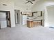 Compact kitchen with a breakfast bar, complete with essential appliances, set in a carpeted area at 500 Fairway Village Dr. # 9-K, Myrtle Beach, SC 29588