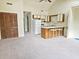 Cozy living room featuring a kitchen with breakfast bar, neutral carpet, and natural light at 500 Fairway Village Dr. # 9-K, Myrtle Beach, SC 29588