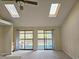 Bright living room featuring two skylights and sliding doors to a balcony with scenic views at 500 Fairway Village Dr. # 9-K, Myrtle Beach, SC 29588