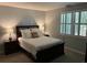 The bedroom features a plush queen-sized bed, shuttered windows, and bedside tables with lamps at 5001 Little River Rd. # W101, Myrtle Beach, SC 29577