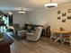 A furnished living room includes a sliding glass door, sofa, chairs, ottoman, and a dining table at 5001 Little River Rd. # W101, Myrtle Beach, SC 29577