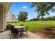 Relaxing outdoor patio with furniture, overlooking the grassy backyard and a scenic treeline at 503 20Th Ave. N # 29-C, North Myrtle Beach, SC 29582