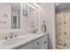Well-lit bathroom with double sinks, white cabinetry, large mirrors, and a shower/tub combination at 503 20Th Ave. N # 29-C, North Myrtle Beach, SC 29582