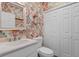 Charming powder room features colorful wallpaper, a white vanity and matching framed mirror at 503 20Th Ave. N # 29-C, North Myrtle Beach, SC 29582