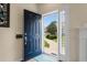 Bright entryway featuring a blue front door that opens to a sunlit view of the front yard at 503 20Th Ave. N # 29-C, North Myrtle Beach, SC 29582
