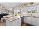 Stylish kitchen featuring granite countertops, white cabinetry, open layout, and natural light at 503 20Th Ave. N # 29-C, North Myrtle Beach, SC 29582