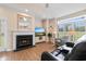 Cozy living room features a fireplace, tv, and windows overlooking the backyard at 503 20Th Ave. N # 29-C, North Myrtle Beach, SC 29582