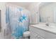 Bathroom featuring a blue seashell-themed shower curtain and a white single sink vanity at 537 White River Dr. # 17C, Myrtle Beach, SC 29579