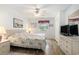 Well-lit bedroom with wood floors, ceiling fan, and dresser with TV, creating a relaxing retreat at 537 White River Dr. # 17C, Myrtle Beach, SC 29579