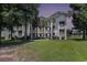 Charming condo building with multiple balconies, palm trees, and well-maintained lawn at 537 White River Dr. # 17C, Myrtle Beach, SC 29579