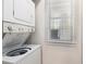Bright laundry area features stacked washer and dryer, plus a window with lots of natural light at 537 White River Dr. # 17C, Myrtle Beach, SC 29579