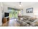 Comfortable living room with ceiling fan, sliding glass doors to the patio, and a view of the pond at 537 White River Dr. # 17C, Myrtle Beach, SC 29579