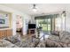 Relaxing living room showcasing a ceiling fan, pond view, and neutral tones to create a calming atmosphere at 537 White River Dr. # 17C, Myrtle Beach, SC 29579