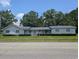 Charming single-story home features a well-manicured lawn, mature trees, and a welcoming front porch at 5370 Miracle Ln., Conway, SC 29526