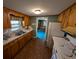 Galley kitchen features wood cabinets, white appliances, and double sink at 5370 Miracle Ln., Conway, SC 29526