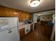 Cozy kitchen with wooden cabinets, white appliances, and view into dining room at 5370 Miracle Ln., Conway, SC 29526