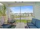Relaxing screened porch with comfortable seating and peaceful views of the pond and neighborhood at 540 Chanted Dr., Murrells Inlet, SC 29576