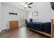 Cozy bedroom with hardwood floors, ceiling fan, desk and chair setup, and window offering natural light at 540 Chanted Dr., Murrells Inlet, SC 29576