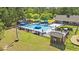 Aerial view of the community pool with blue umbrellas and plenty of lounge seating on a sunny day at 540 Chanted Dr., Murrells Inlet, SC 29576