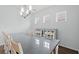 Dining room with bright natural light, a long table with seating for ten, and modern chandelier at 540 Chanted Dr., Murrells Inlet, SC 29576