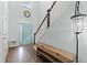 Inviting foyer with a wooden bench, staircase, and stylish light fixture at 540 Chanted Dr., Murrells Inlet, SC 29576