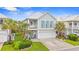 Charming two-story beach home featuring palm trees, a front porch, and a two-car garage at 540 Chanted Dr., Murrells Inlet, SC 29576