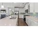 Well-equipped kitchen featuring white cabinets, stainless steel appliances, and a large breakfast bar at 540 Chanted Dr., Murrells Inlet, SC 29576