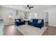 Bright living room featuring two blue couches, a large TV, and access to a kitchenette at 540 Chanted Dr., Murrells Inlet, SC 29576