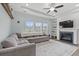 Cozy living room with a fireplace, built-in shelving, large gray sofa and ample natural light at 540 Chanted Dr., Murrells Inlet, SC 29576