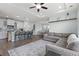Open-concept living space features a sofa, kitchen island with bar stools, and dining area at 540 Chanted Dr., Murrells Inlet, SC 29576
