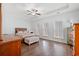 Bright main bedroom featuring tray ceilings, three windows, hardwood floors, and a neutral color scheme at 540 Chanted Dr., Murrells Inlet, SC 29576