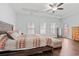 Spacious main bedroom featuring three bright windows, access door, hardwood floors, and tray ceiling at 540 Chanted Dr., Murrells Inlet, SC 29576