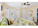 Comfortable bedroom with ceiling fan, ensuite, and access to an outdoor patio at 6001- P16A S Kings Highway, Myrtle Beach, SC 29575