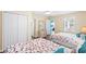 Cozy bedroom with twin beds, soft decor, closet, and views into the bright living area at 6001- P16A S Kings Highway, Myrtle Beach, SC 29575