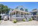 Beautiful two-story home with a covered front porch and well-manicured landscaping at 6001- P16A S Kings Highway, Myrtle Beach, SC 29575