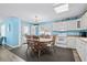 Bright eat-in kitchen with white cabinets and modern appliances plus a wooden dining set at 6001- P16A S Kings Highway, Myrtle Beach, SC 29575