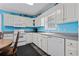 Bright kitchen with white cabinetry and modern appliances, and light blue walls at 6001- P16A S Kings Highway, Myrtle Beach, SC 29575
